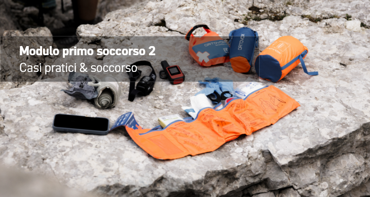 first aid kit, emergency blanket, cell phone, watch, rocky terrain